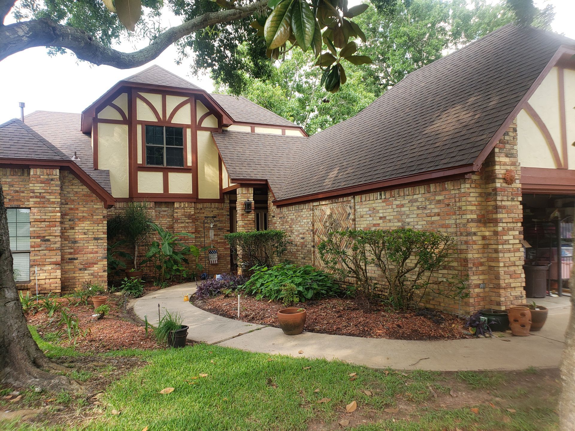 A large brick house with a brown roof