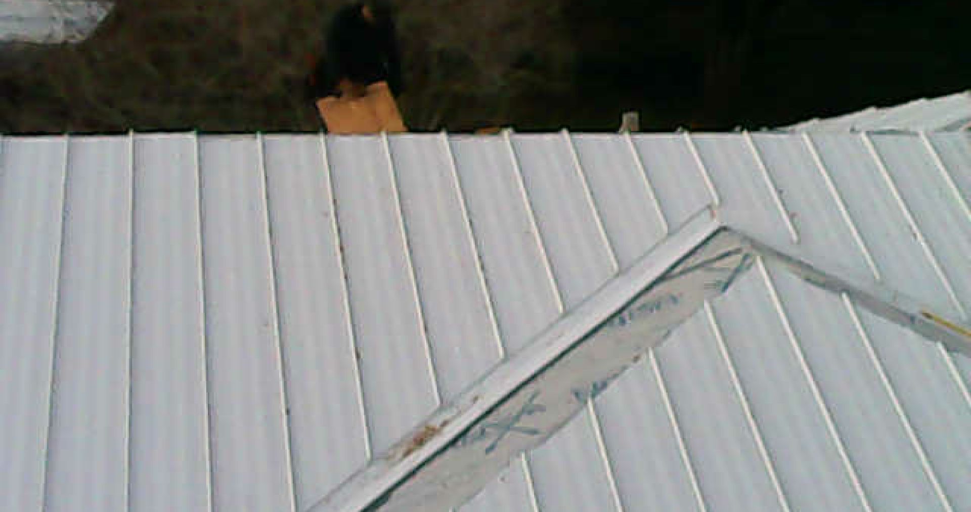 An aerial view of a white metal roof