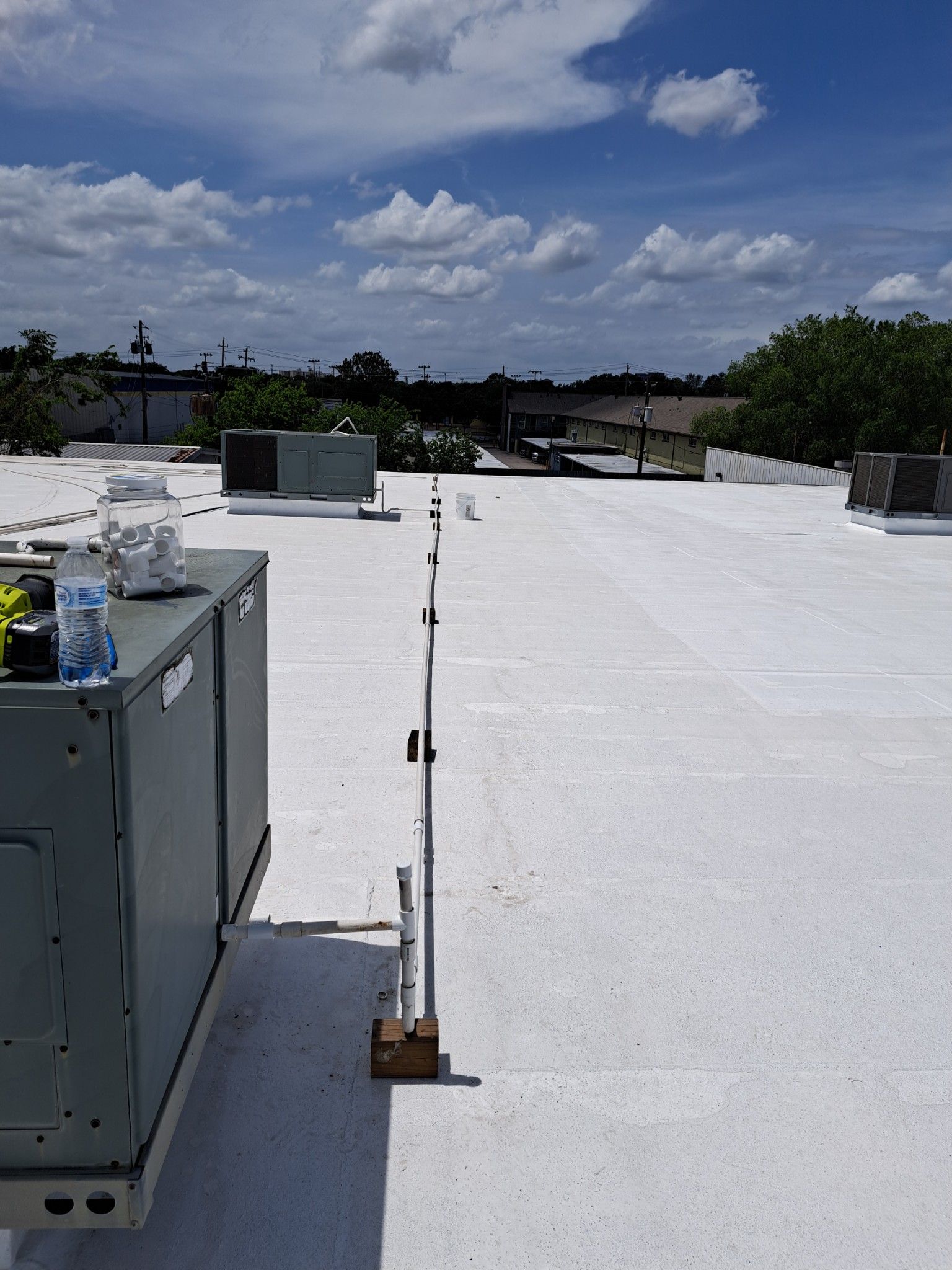 A white roof with a few boxes on it