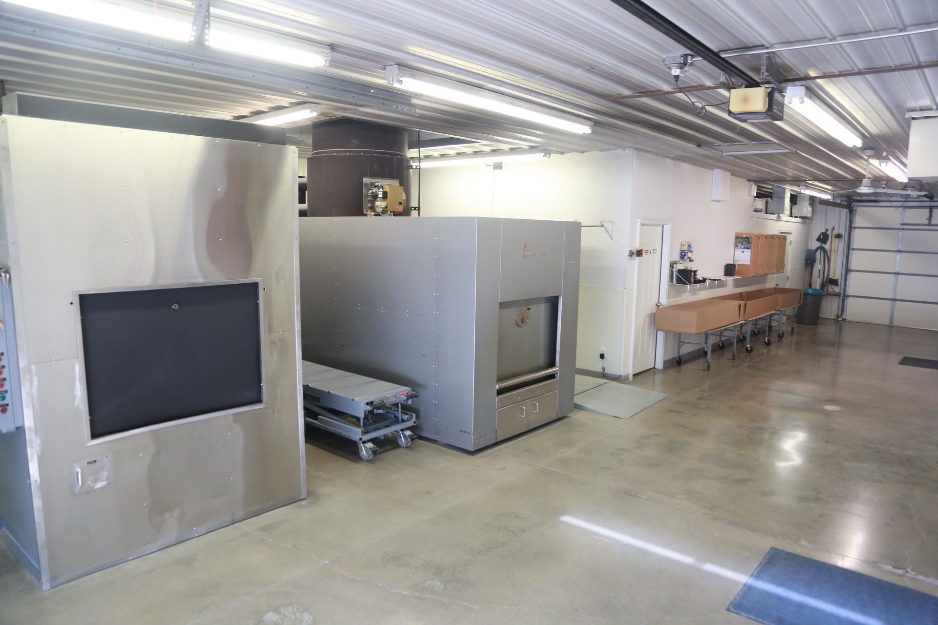 A large room with a lot of stainless steel appliances in it.