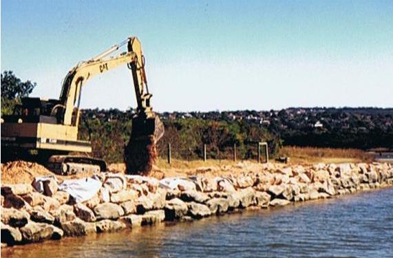 excavator next to water