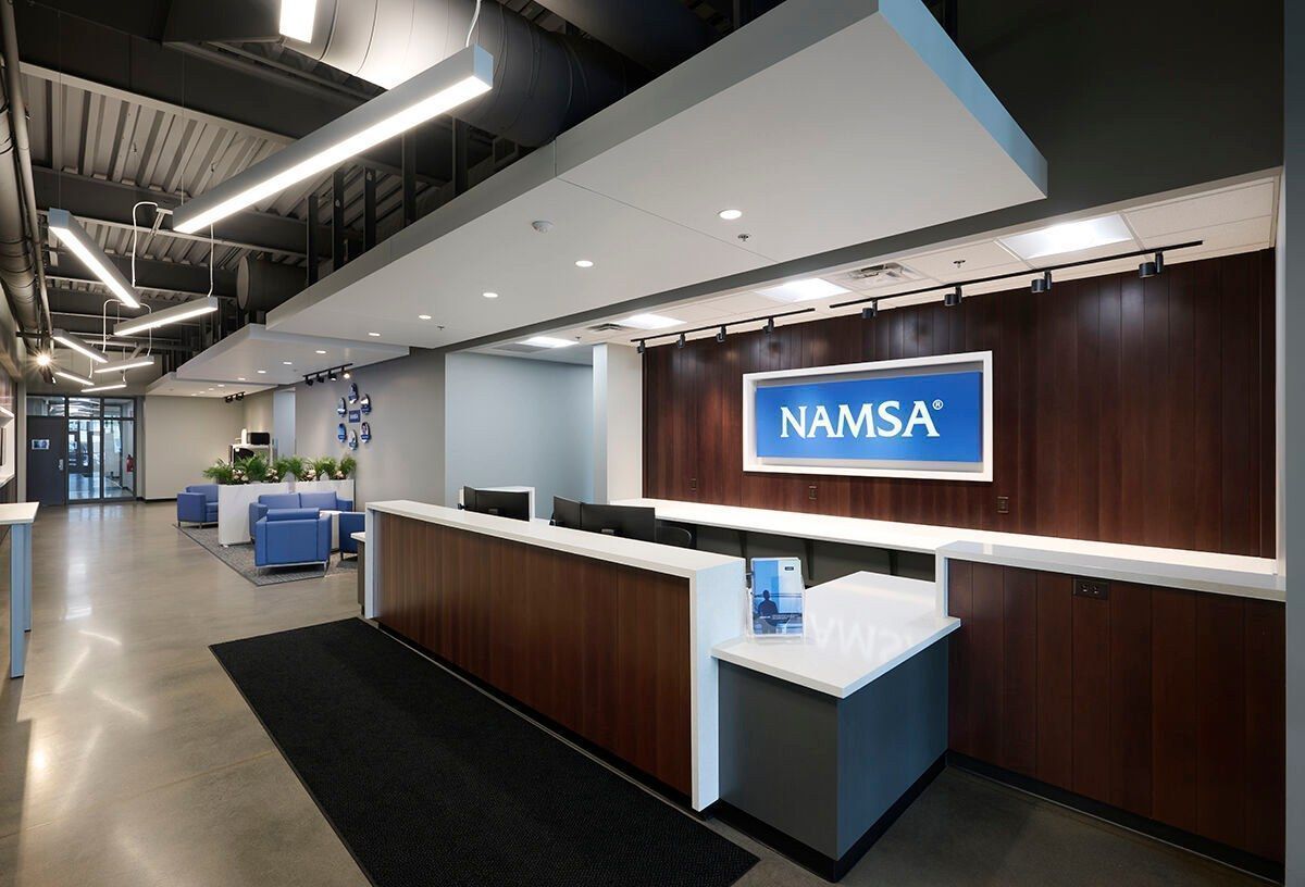 A lobby with a sign that says namsa on it