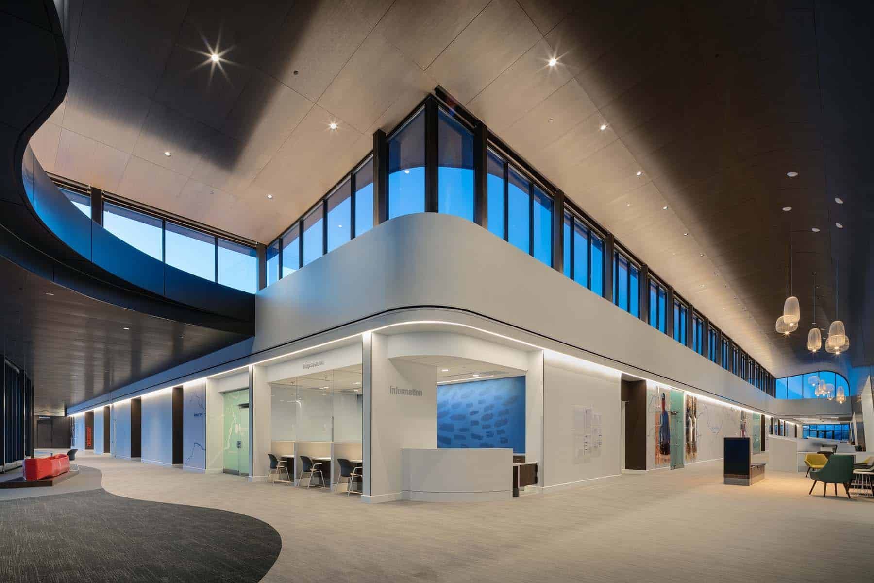 A large building with a lot of windows and a blue sky in the background