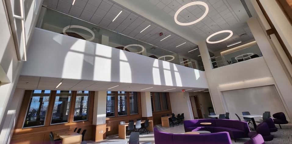 A large building with a lot of windows and purple furniture