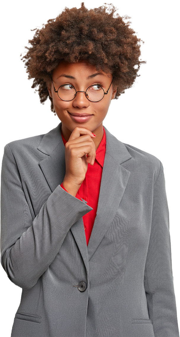 Woman with curly hair and glasses, wearing a blazer, thoughtfully touching her chin.