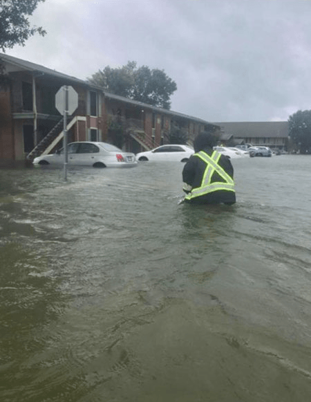 man wading through flood