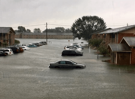 flooded parking lot of apartment complex
