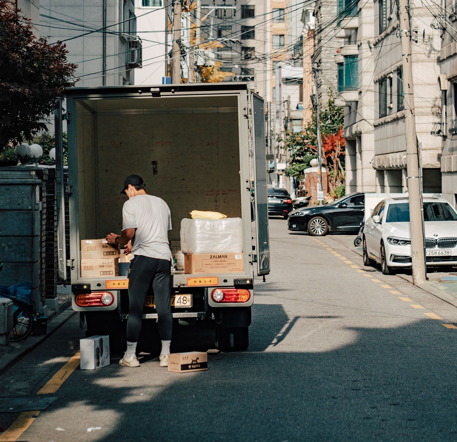 Worker efficiently moving packages during truck loading/unloading.