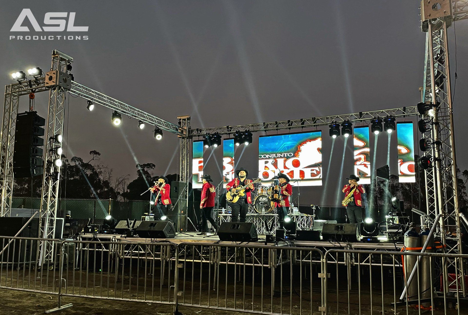 a group of people are standing on a stage with asl productions written on the bottom