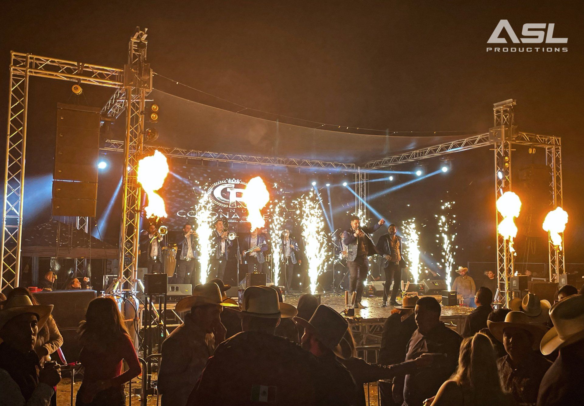 a group of people are standing in front of a stage that says asl on it