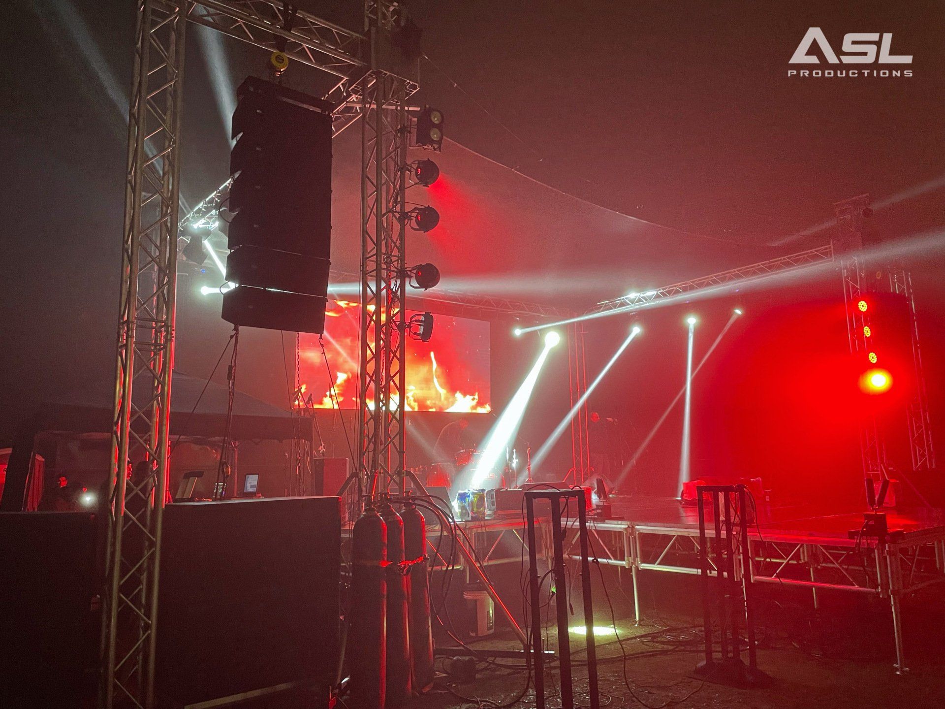 a stage with red lights and a sign that says asl