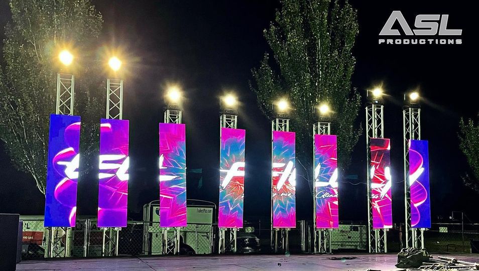 a row of asl productions signs are lit up at night