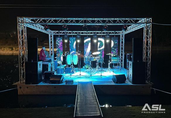 a stage set up for a concert with a dock leading to it .