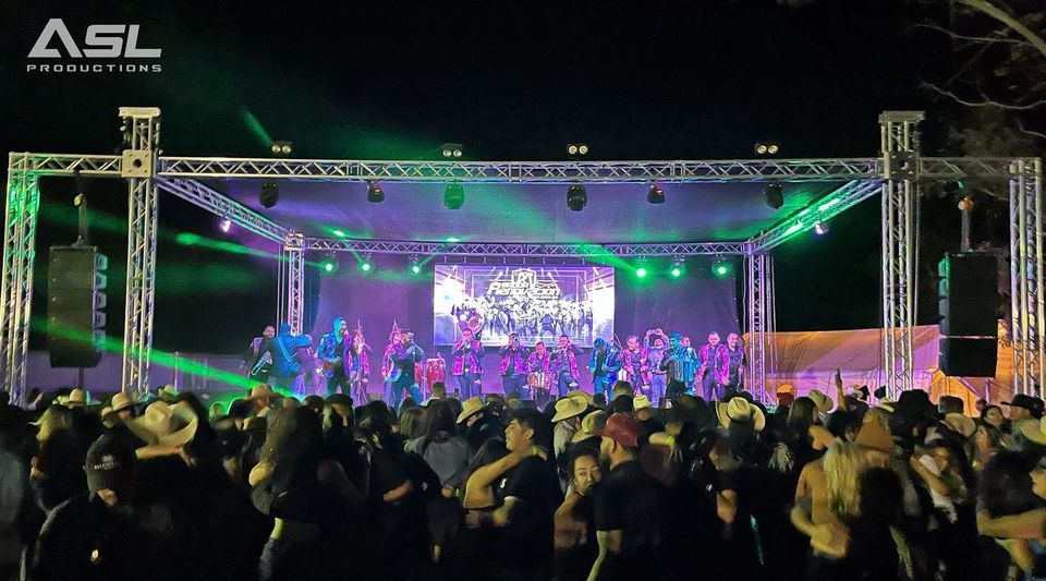 a large crowd of people are gathered in front of a stage that says asl