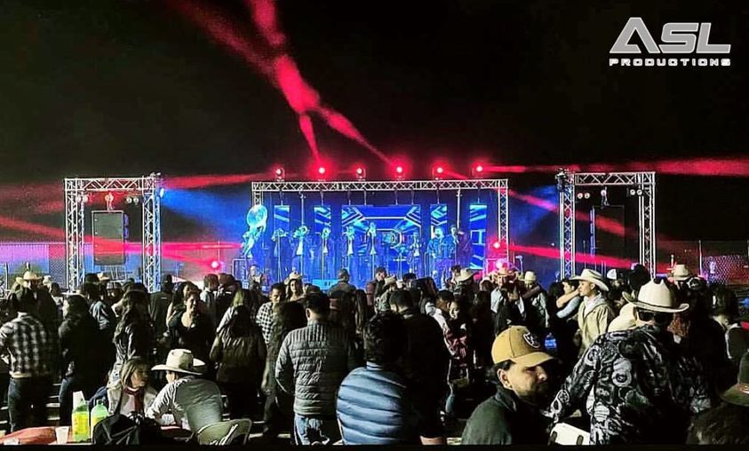 a large crowd of people are gathered in front of a stage that says asl productions