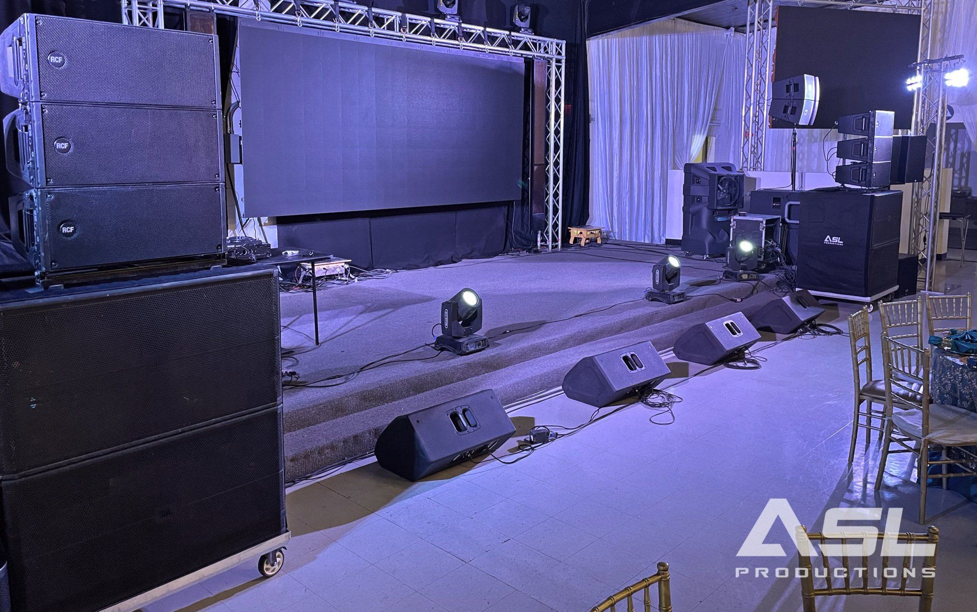 a stage with a lot of speakers and lights on it .