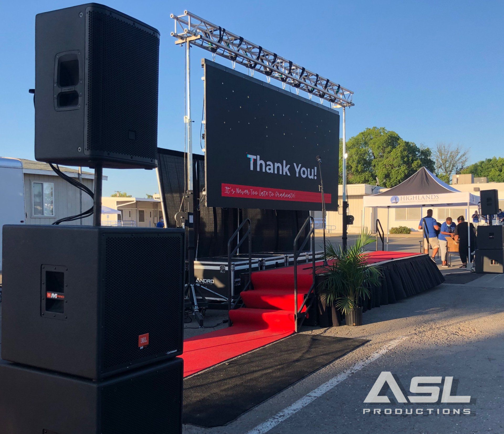 a stage with speakers and a sign that says thank you