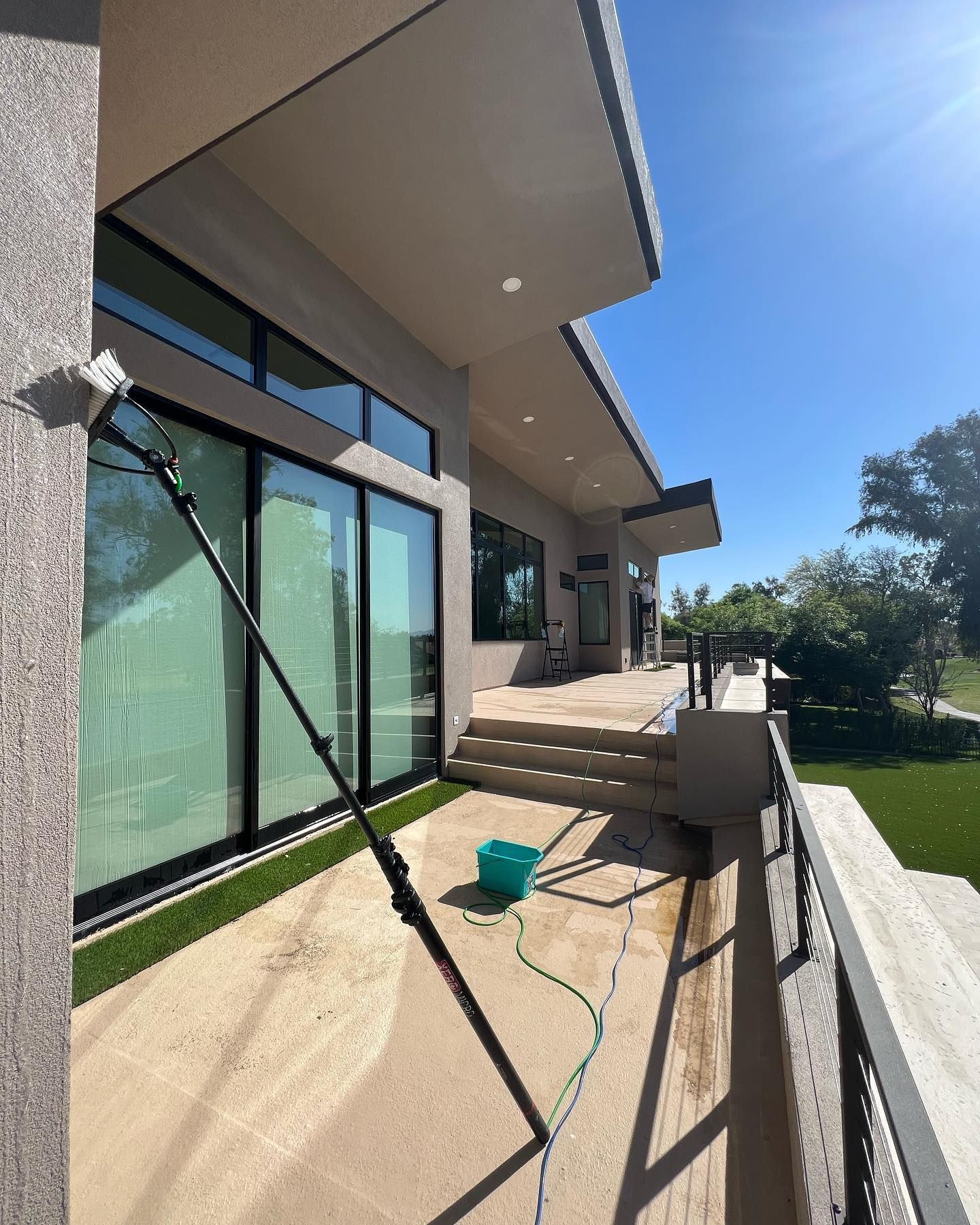 A large house with a balcony and a hose attached to it.