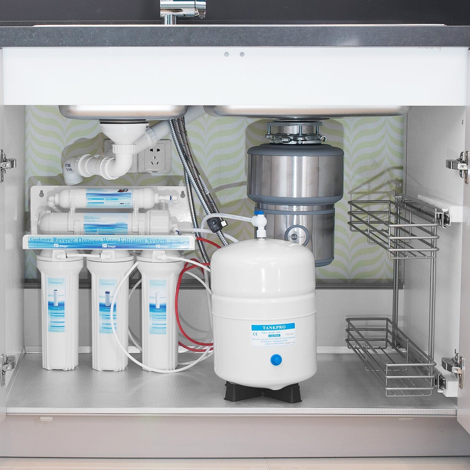 The inside of a kitchen sink with a water filter and a garbage disposal