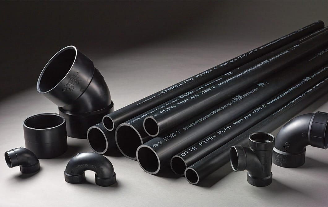 A bunch of black pipes and fittings on a table