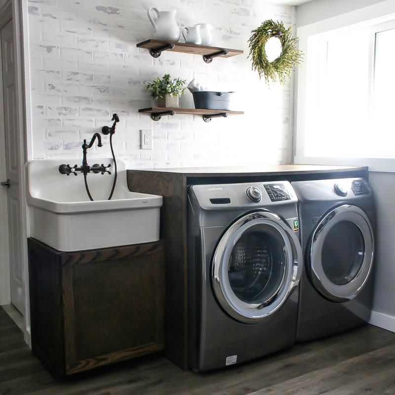 A laundry room with a washer and dryer and a sink