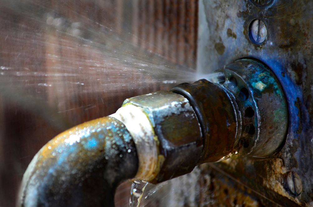 A close up of a faucet with water coming out of it.