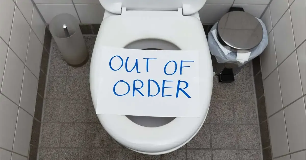 Toilet with a sign that reads