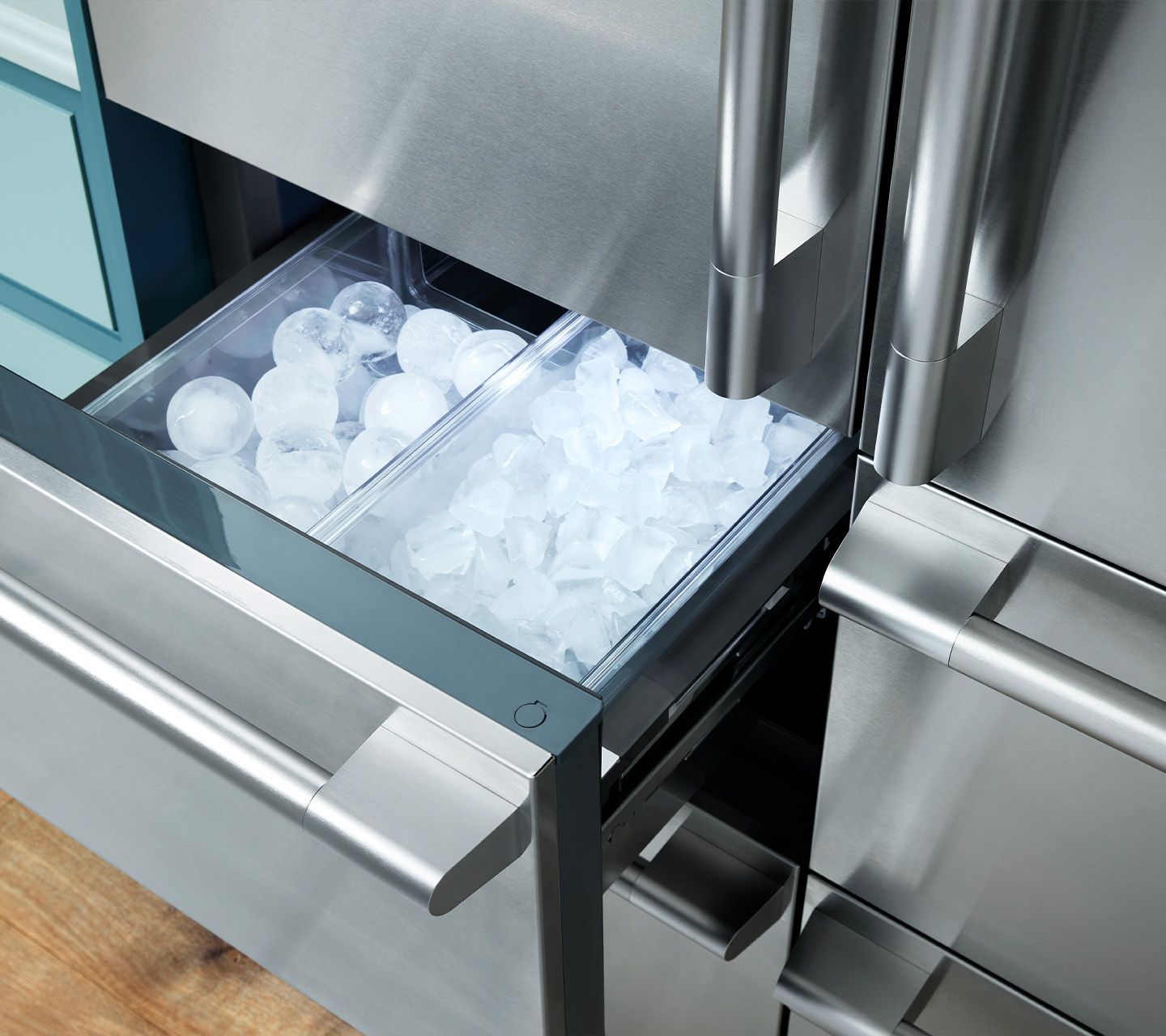 A stainless steel refrigerator drawer filled with ice cubes