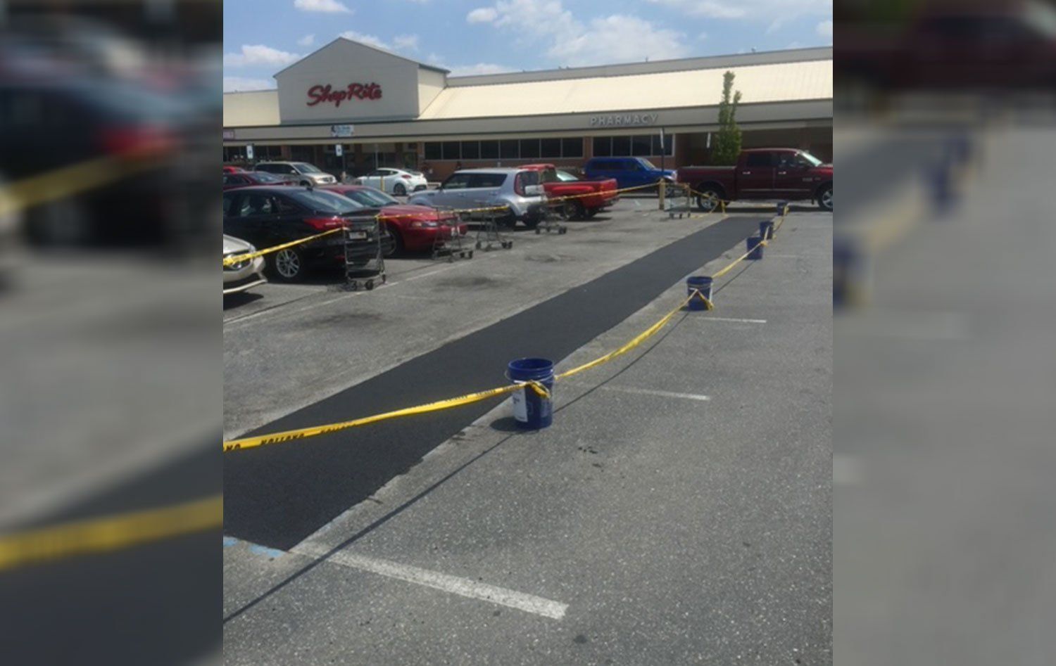 A parking lot with cars parked in front of a store.