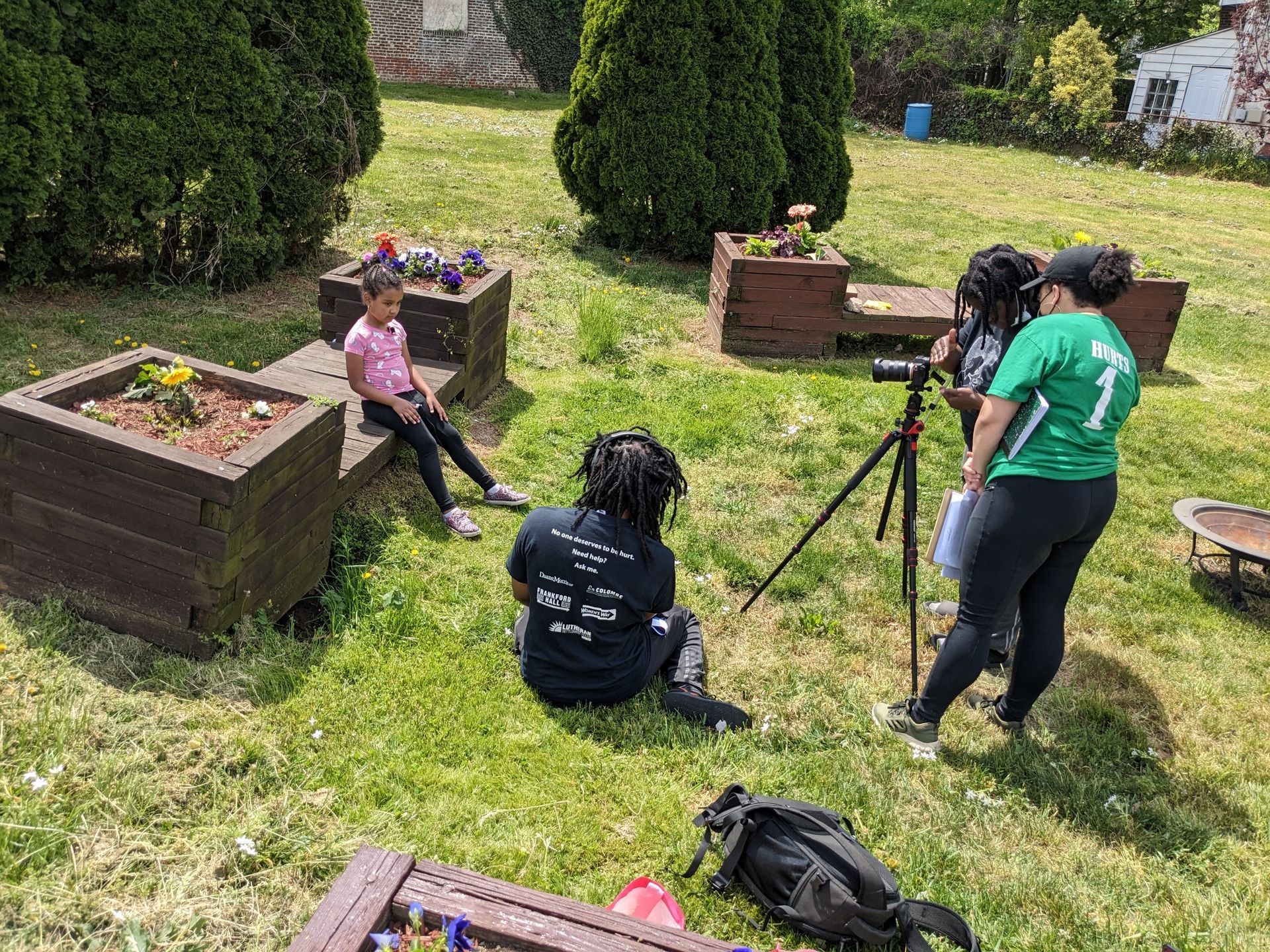 A group of people are sitting around a wooden table in a room.