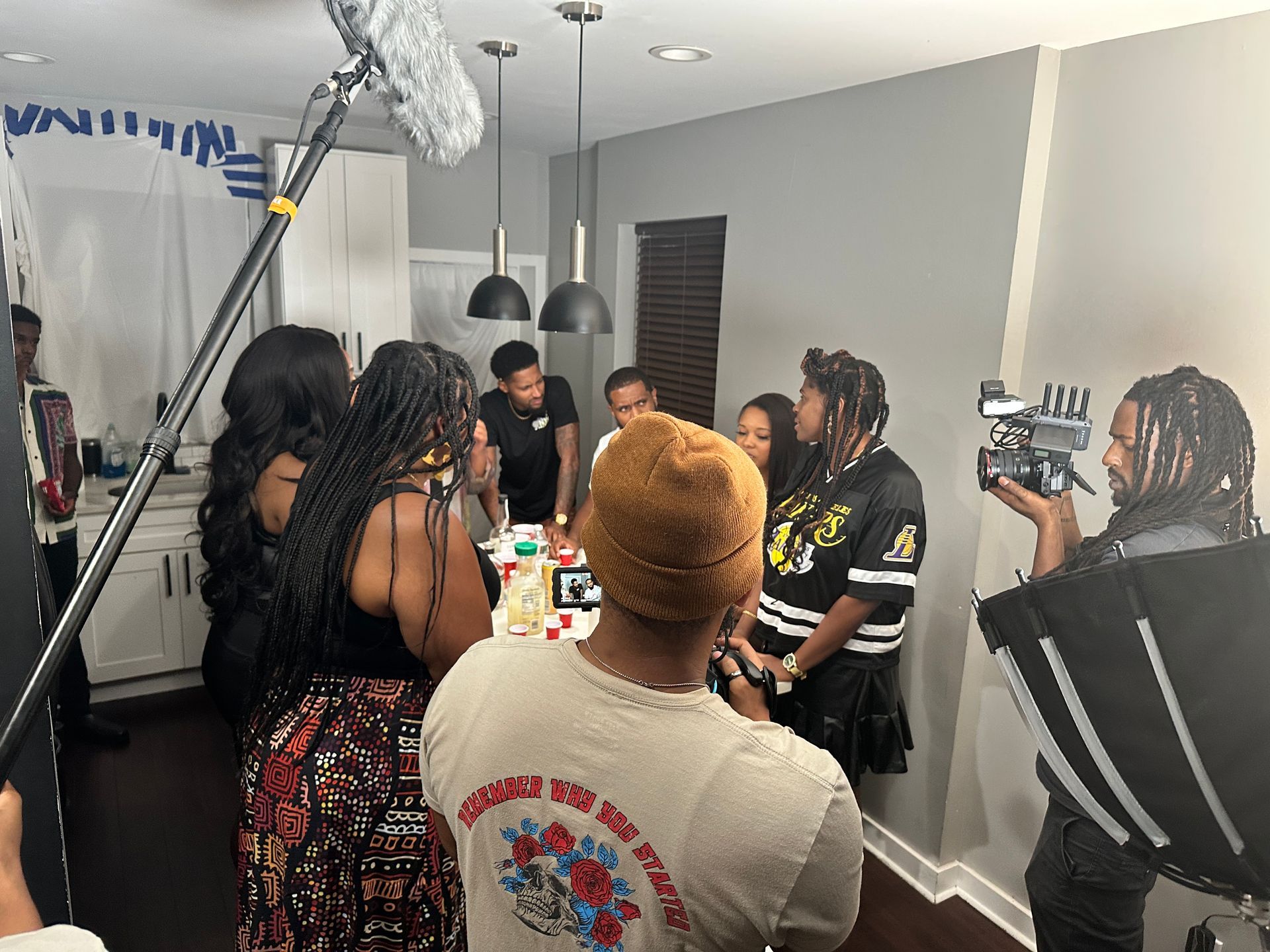 A man holding a clapper board that says a song for nia ep 3