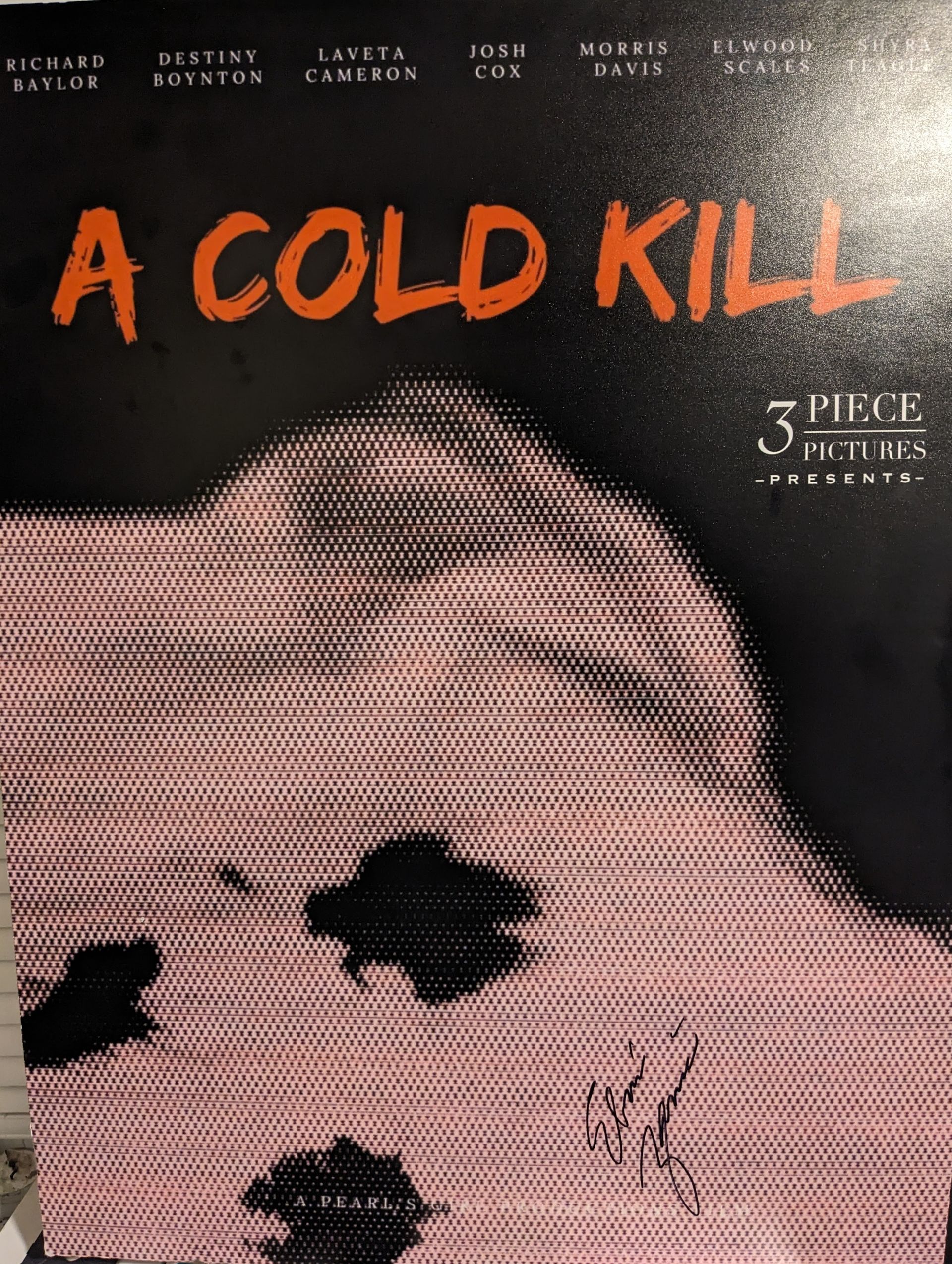 A man wearing headphones is sitting at a desk using a computer.