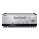Silver stereo amplifier with a large volume knob and front display on a white background
