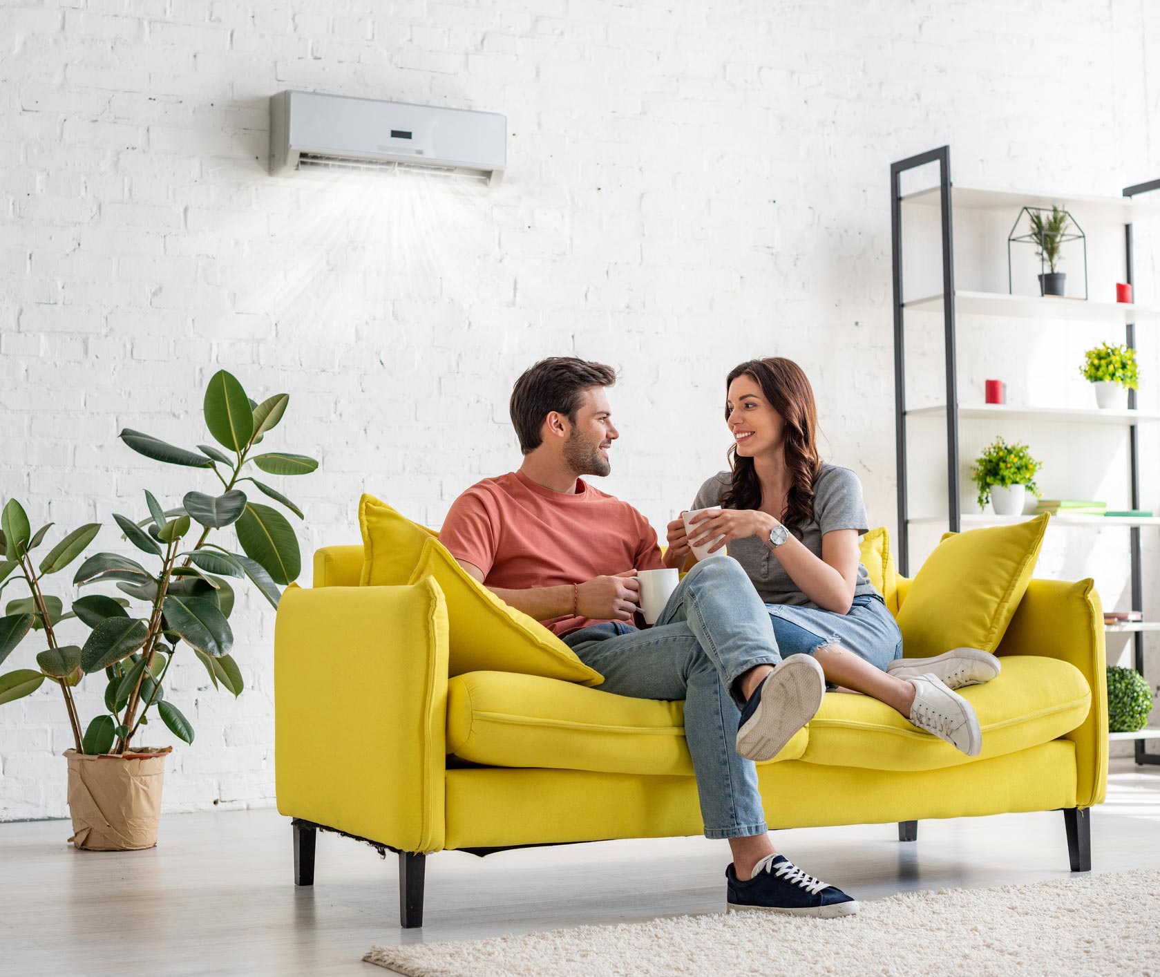 Young Couple Under Air Conditioner — Pompano Beach, FL — Top Notch AC Services