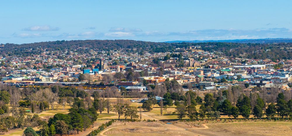 An Aerial View Of A City Surrounded By Trees And A Field — About Time Plumbing & Civil Construction in Goulburn, NSW