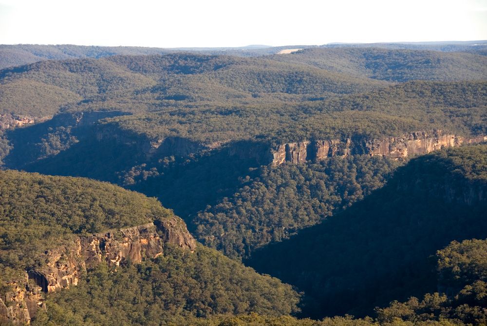 A View Of A Valley Surrounded By Mountains And Trees — About Time Plumbing & Civil Construction in Bundanoon, NSW