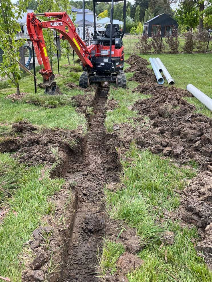 Red Excavator in Residential — About Time Plumbing & Civil Construction in Moss Vale, NSW