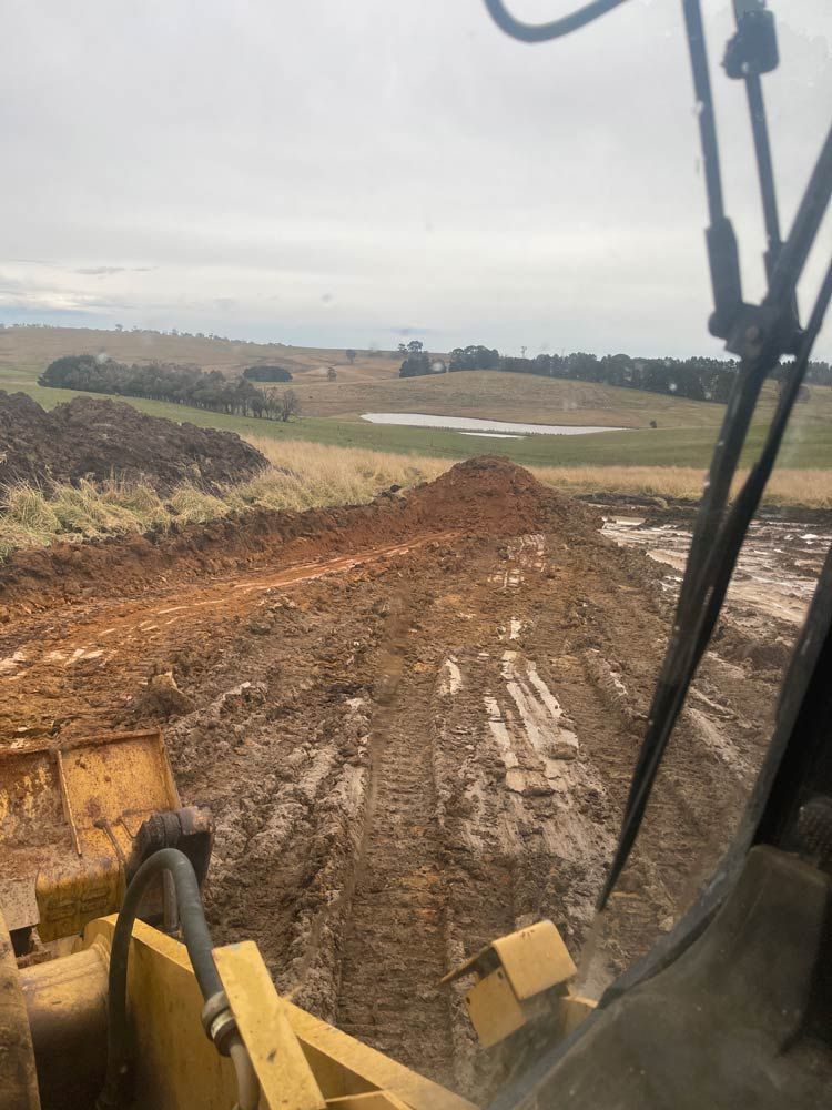 Driving an Excavator — About Time Plumbing & Civil Construction in Moss Vale, NSW