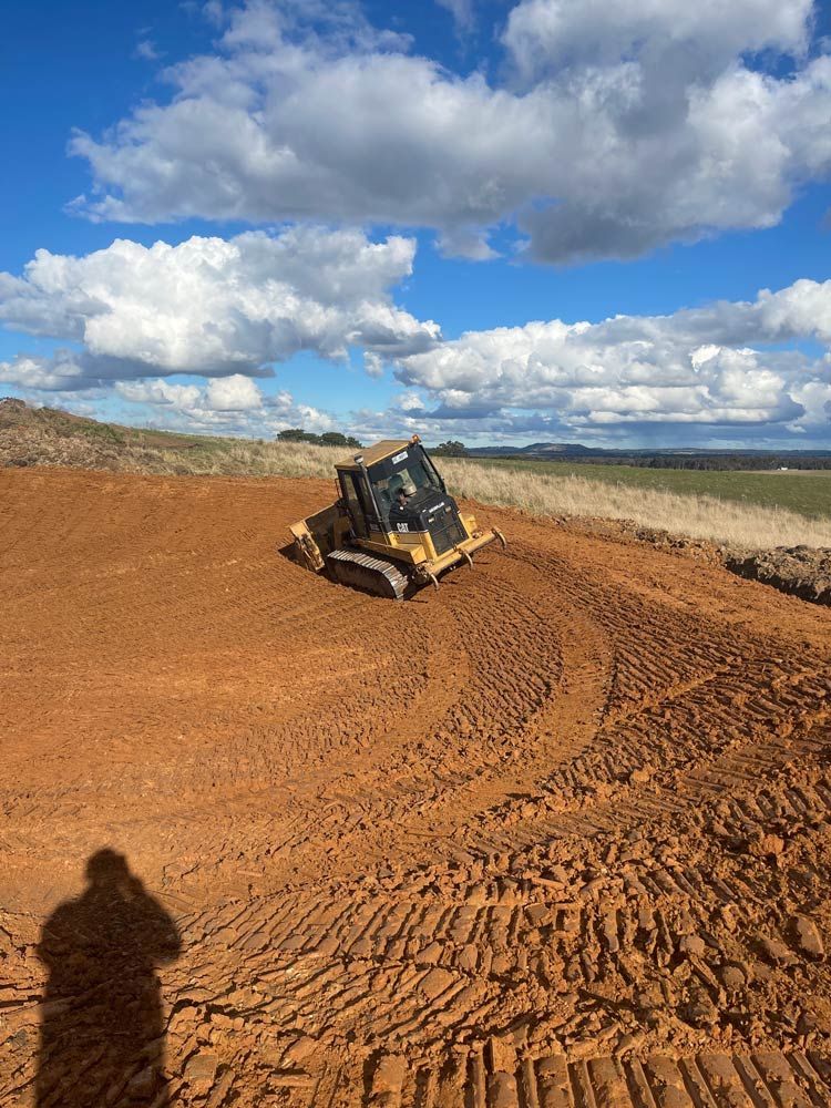 Excavator in Field — About Time Plumbing & Civil Construction in Moss Vale, NSW