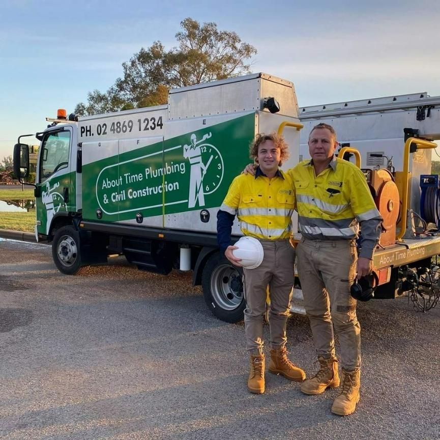 Two Men Standing Next to Company Truck — About Time Plumbing & Civil Construction in Moss Vale, NSW