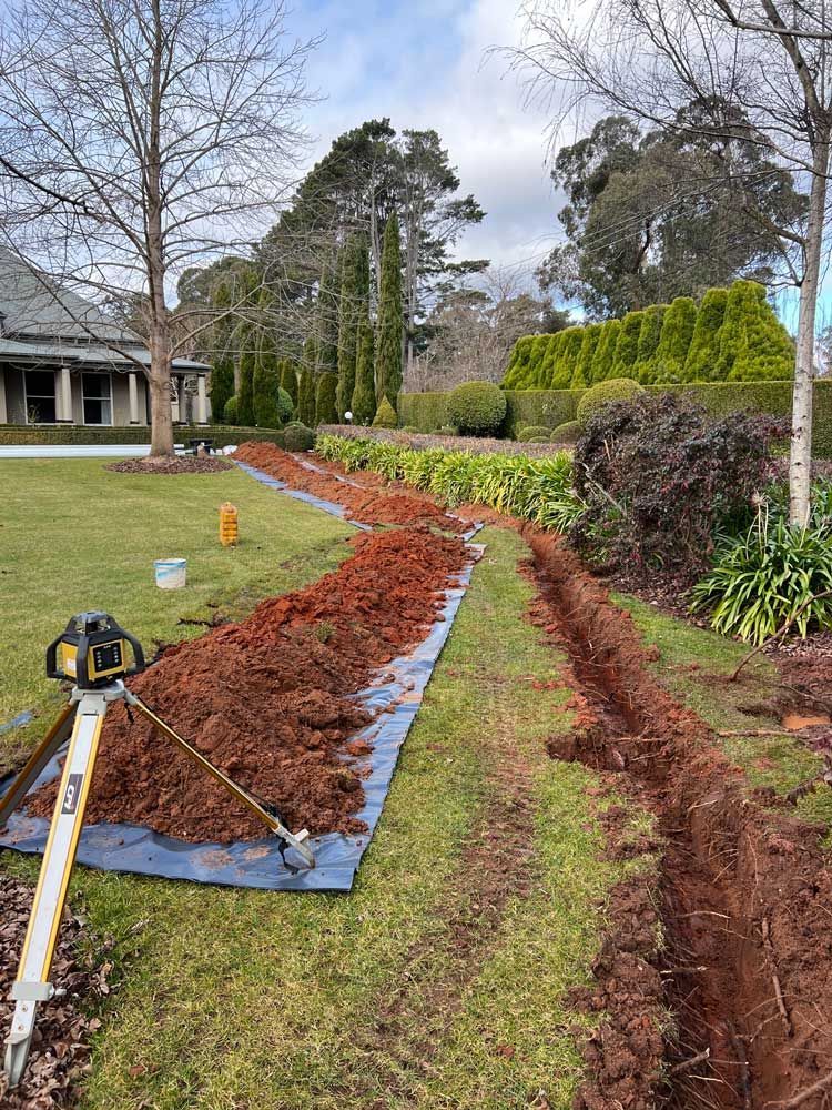 Excavated Lawn For Pipe Installation — About Time Plumbing & Civil Construction in Moss Vale, NSW