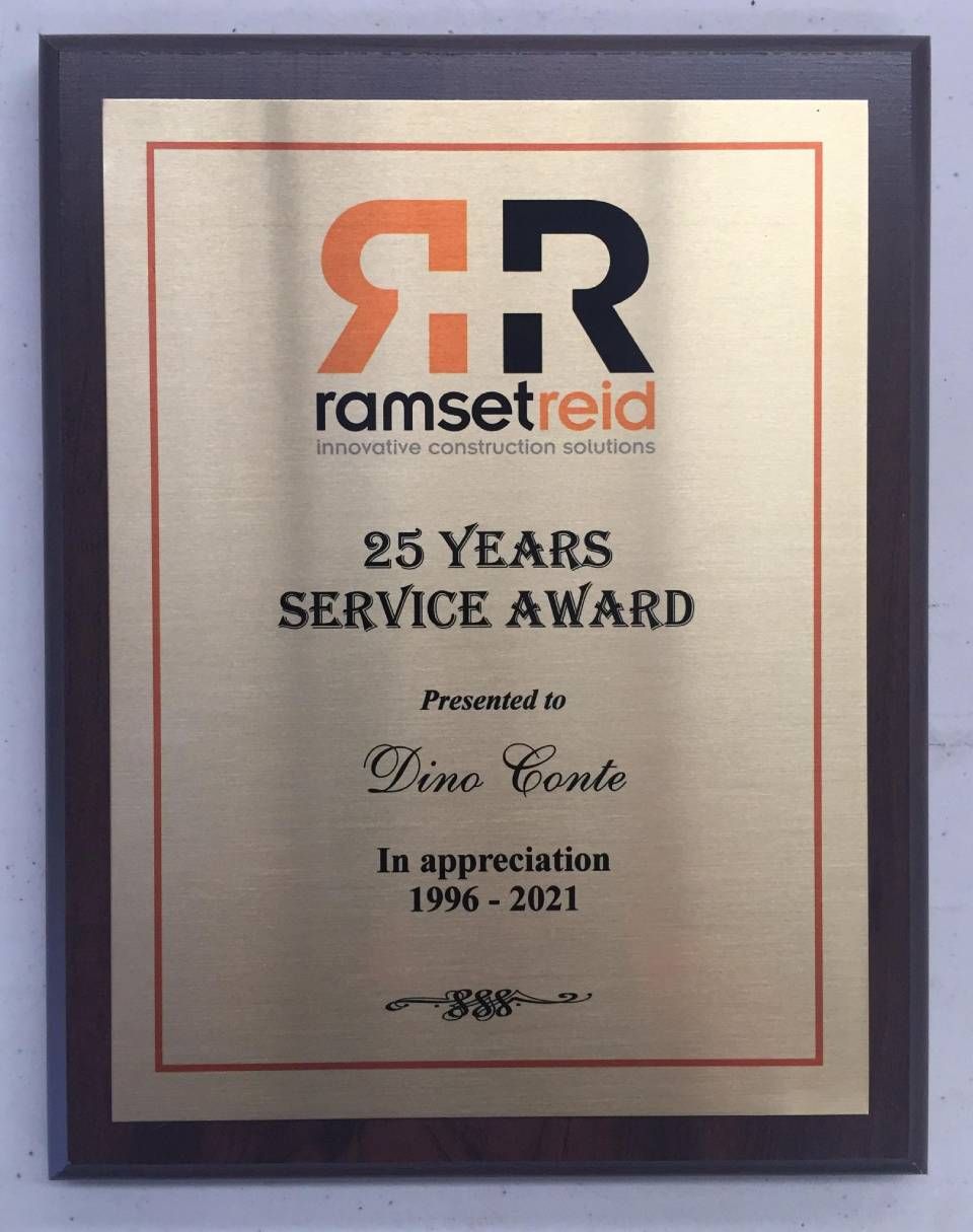 Plaque for Dino Conte, 25 Years Service Award, presented by RamsetReid. Brass plate on a wood base.