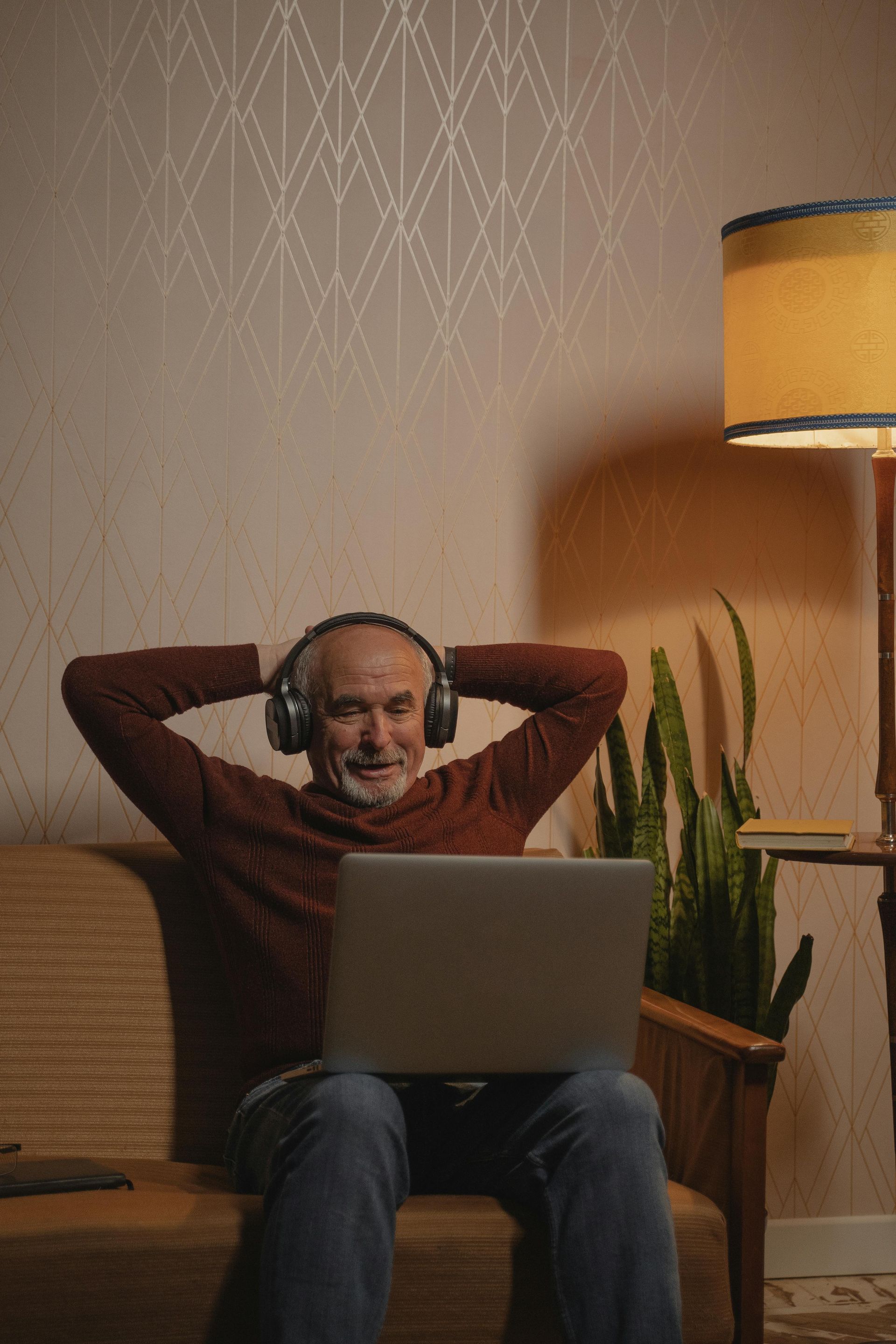 An image of an older woman relaxing in her desk chair.