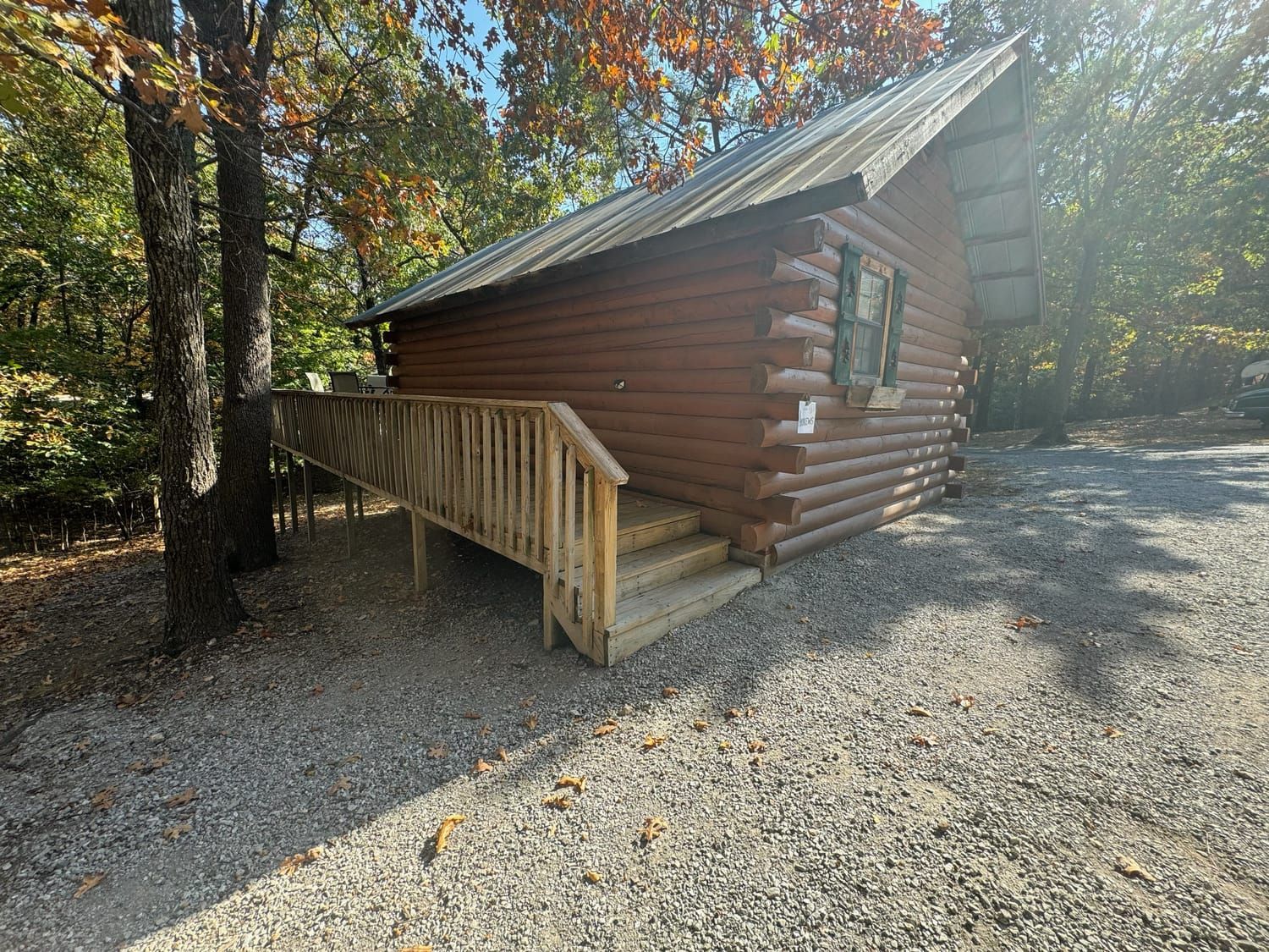 A small log cabin with a ramp and stairs.