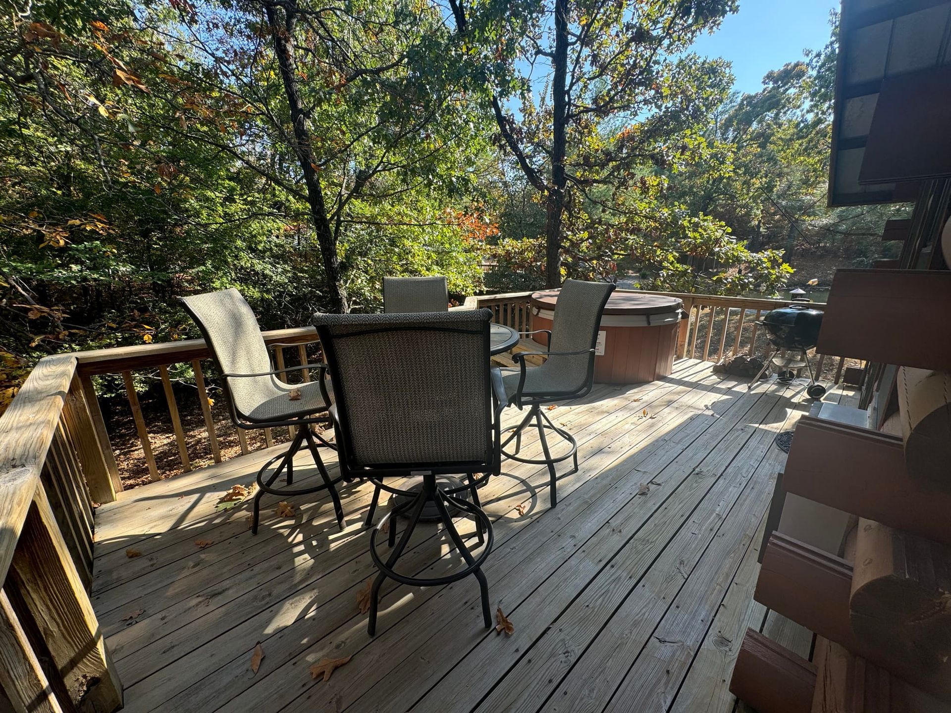 A wooden deck with a table and chairs on it.
