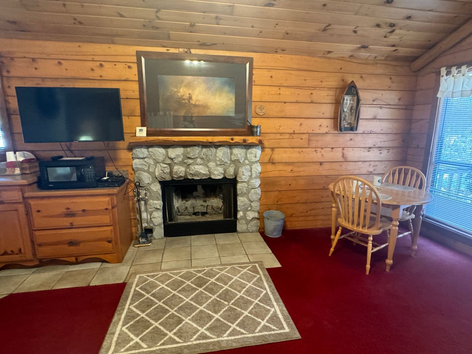 A living room with a fireplace and a television