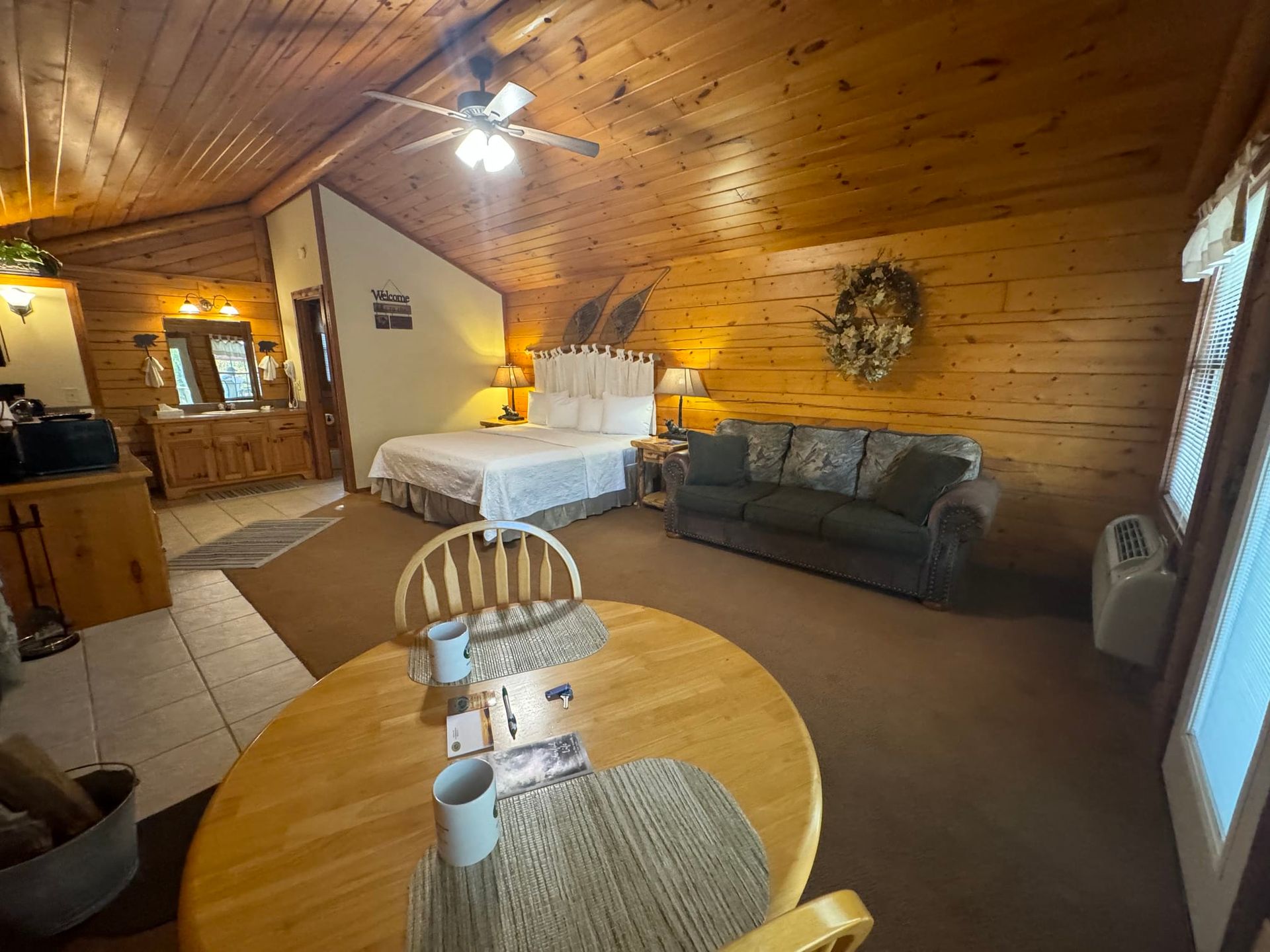 There is a table and chairs in the middle of the room.