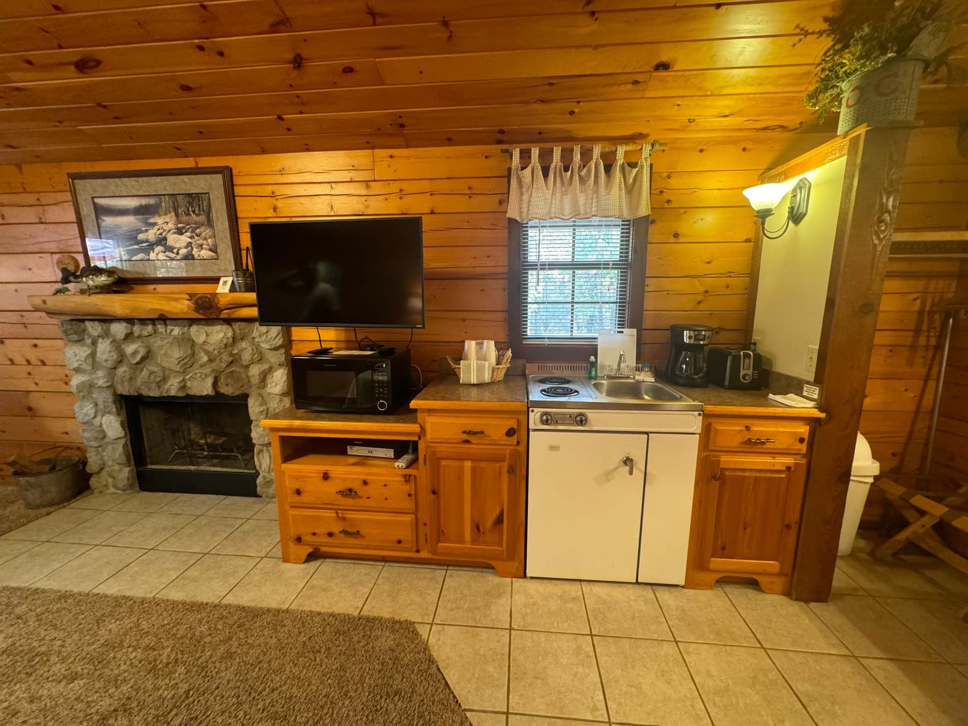 A living room with a fireplace and a flat screen tv