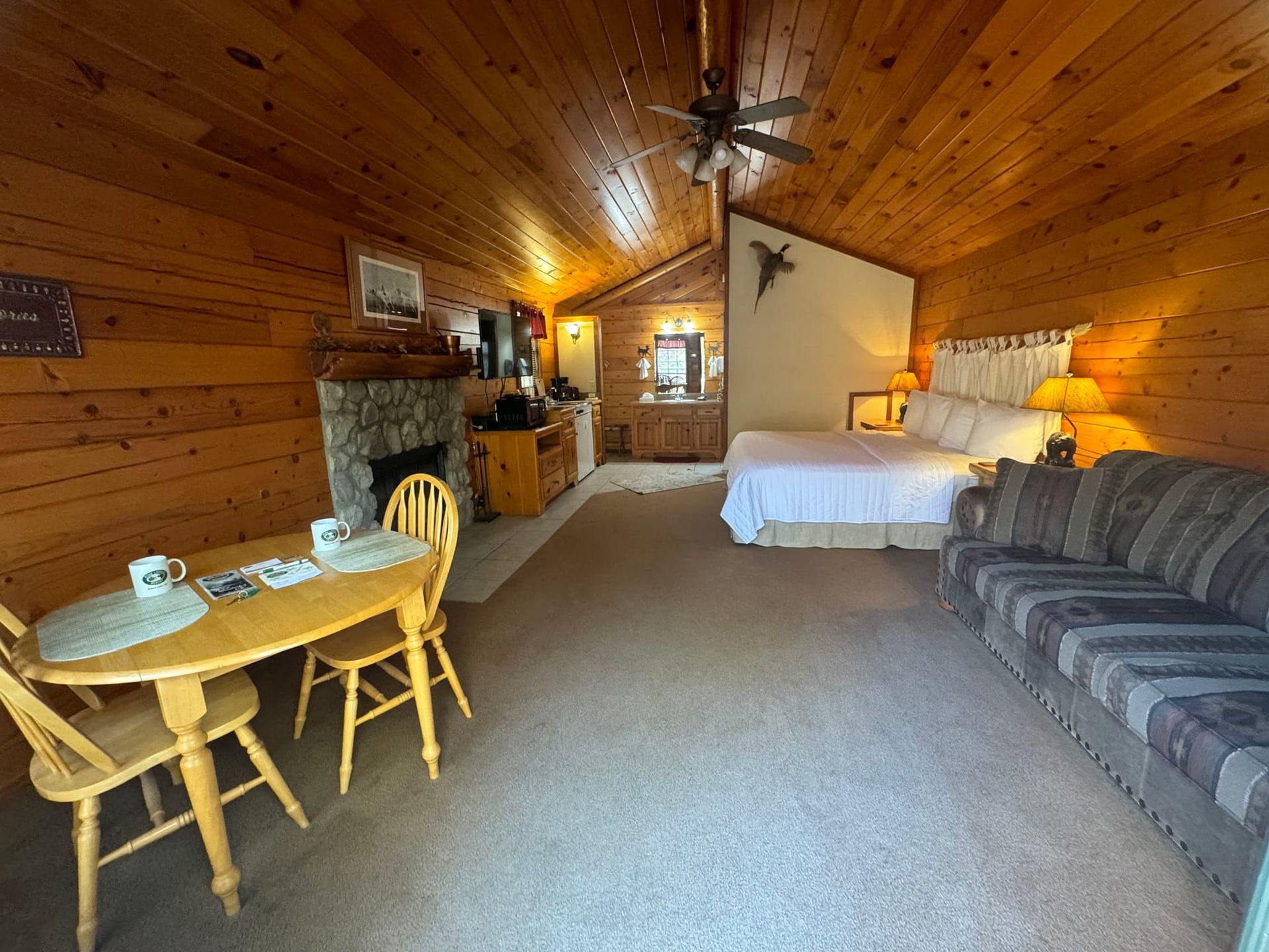 There is a table and chairs in the middle of the room.