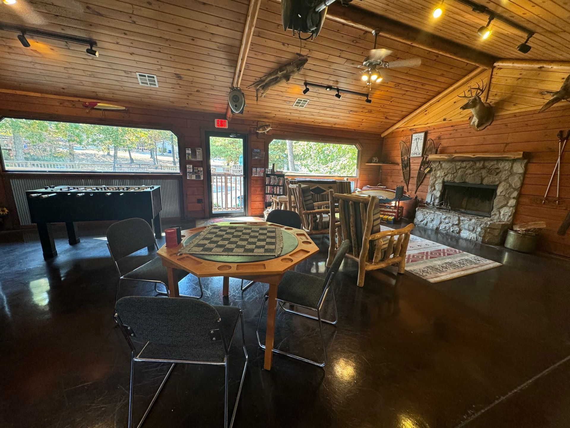 There is a table with a chess board on it in the middle of the room.